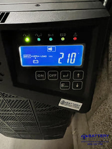 6KVA 10KVA BBP UPS Providing Critical Emergency Backup Power To Facility Plus Voltage Regulation, Frequency Correction, And Power Conditioning To Electrical Sub Panel - Front LCD View Of Current Facility Voltage